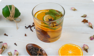 tea cup in a table surrounded by herbs