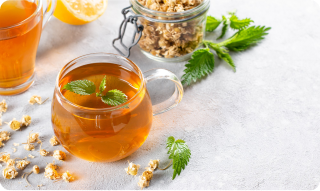 tea cup in a table surrounded by herbs